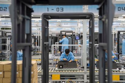 Technicians assemble DC charging piles for electric vehicles at a workshop in Hefei, Anhui province, China, Oct 13, 2023
