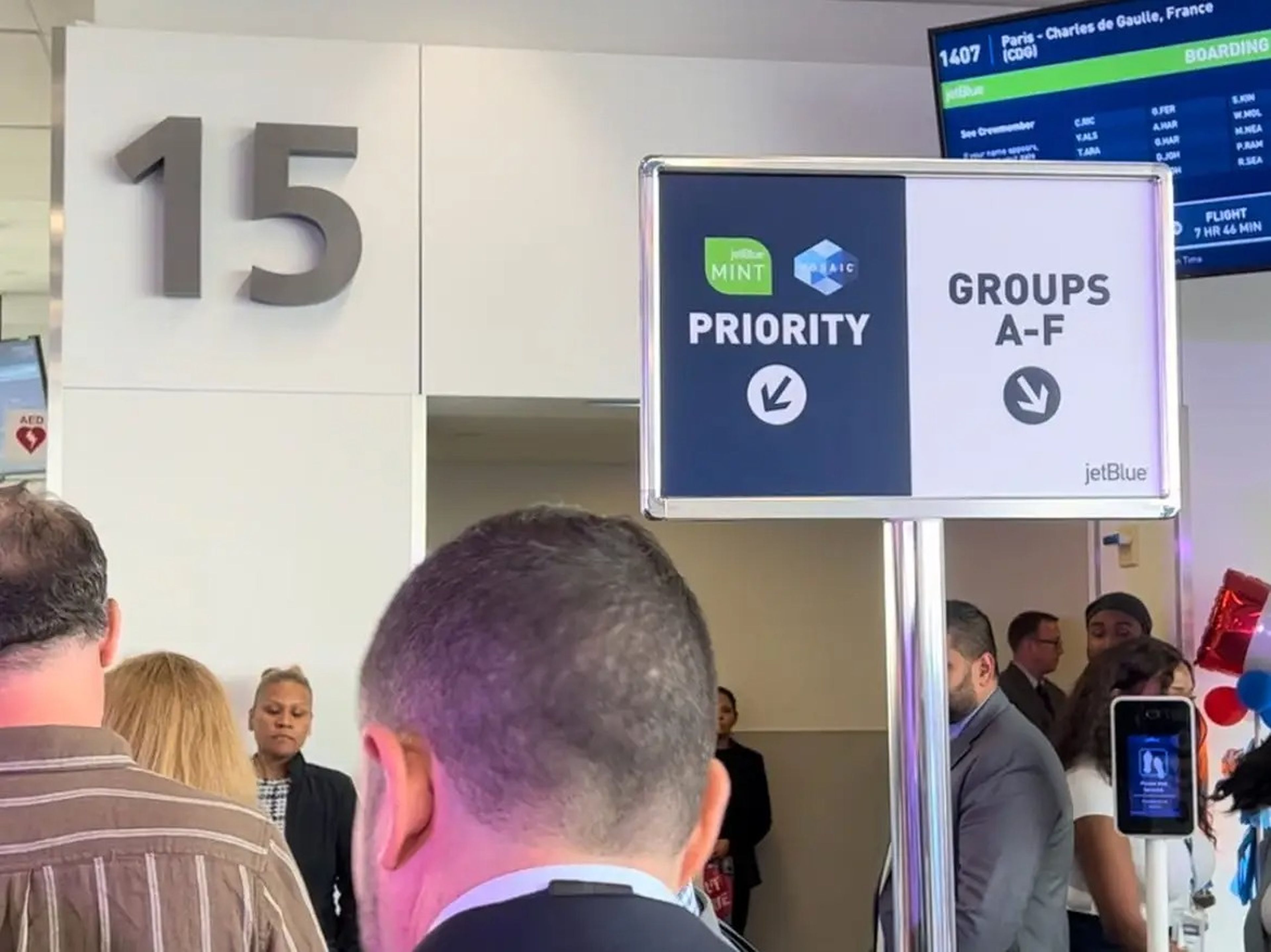 A short line of people boarding in JetBlue's priority lane.