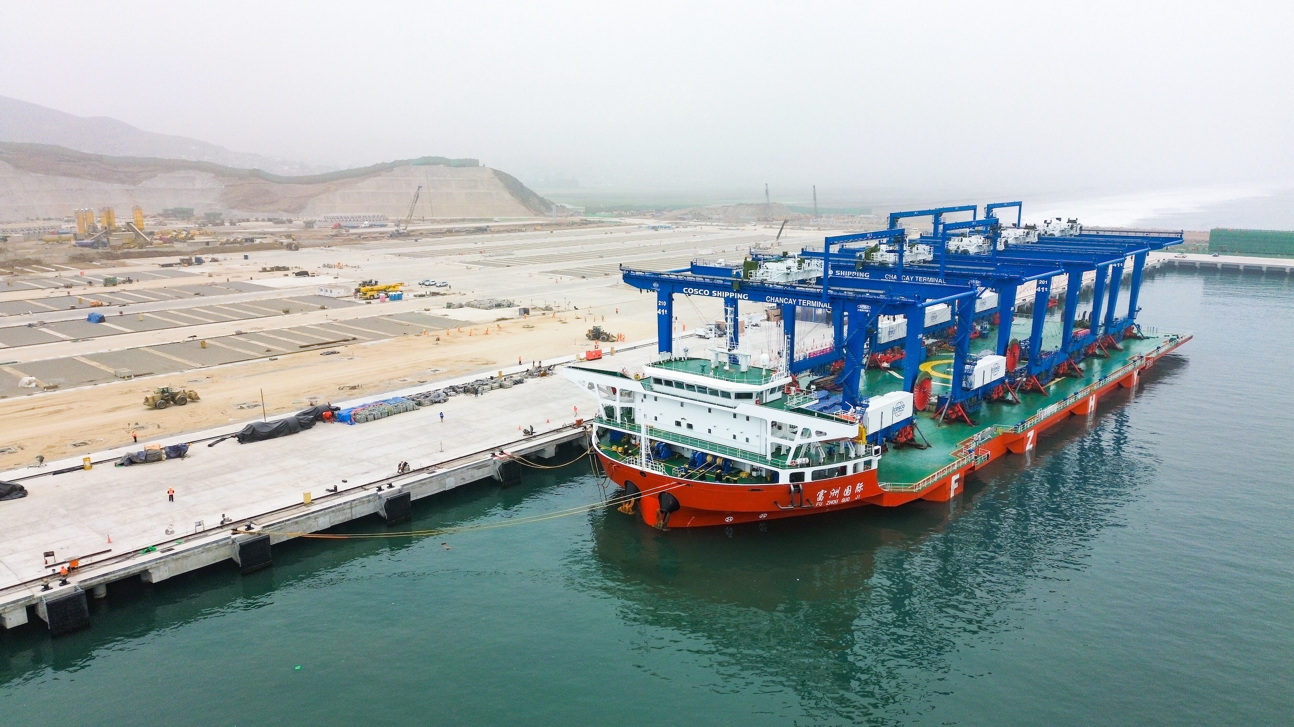 A large cargo ship is docked at a port